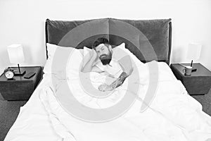 Insomnia. Sleep disorders concept. Man bearded hipster having problems with sleep. Guy lying in bed try to relax and