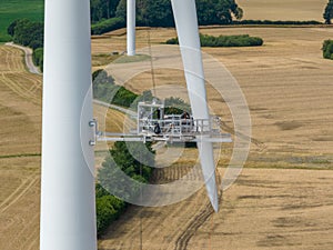 Inspection engineer preparing and progress check of a wind turbine by wind farm. Repair work on the blades of a windmill for elect