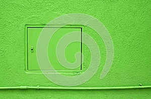 Inspection hatch on green wall