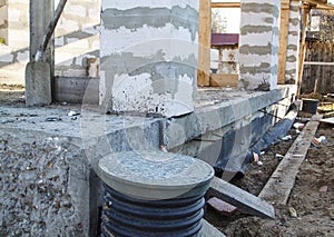 inspection manhole and concrete foundation porches with supporting columns of foam blocks on the perimeter