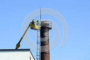 Inspection of the technical condition of an old tall brick chimney using a telescopic boom platform