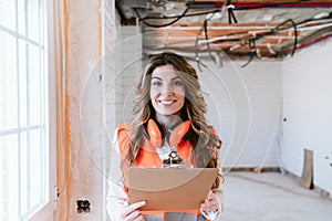 Inspector or architect professional woman checking kitchen at construction site. Home improvement