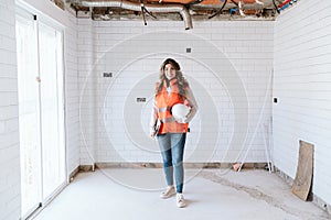 Inspector or architect professional woman checking kitchen at construction site. Home improvement