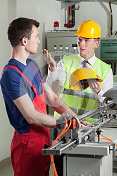 Inspector controlling safety during work at factory