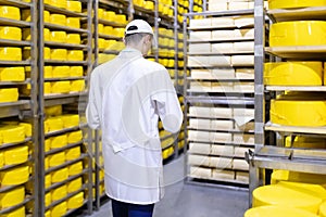 Inspector makes notes in the sheet at the cheese warehouse