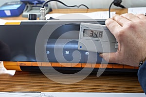 The inspector is measuring density of radyograph film with densitometer. Densitometer for measuring the transmission density.