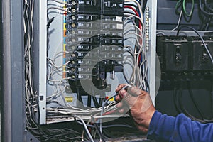 Inspector men hands working switchboard machinery maintenance service. Electrical mechanic technician check wire electric cabinet