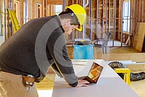 Inspector in new construction house with tablet making notes