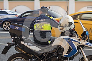 The inspector of the road police patrol on the service motorcycle controls the road