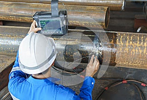 Inspectors Check Defects in Welded add Joints of Steel Pipe with Process Ultrasonic testing (UT)