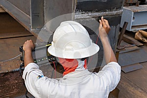 Inspectors are checking defect in welded with process Ultrasonic testing UT photo