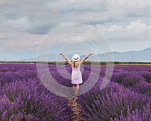 Inspiration and creativity concept, woman in inspiring landscape of lavender blooming field