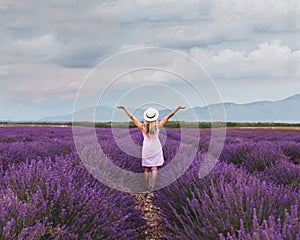Inspiration and creativity concept, woman in inspiring landscape of lavender blooming field photo