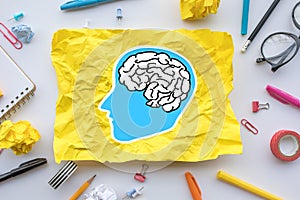 Inspiration creativity concepts with brain drawing on paper crumpled on worktable