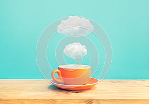 Inspiration creativity concepts with a cup of coffee on wood bar table with some cloud on blue sky color background