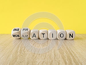 Inspiration or mobilization symbol. Concept words Inspiration and Mobilization on wooden cubes. Beautiful yellow background,