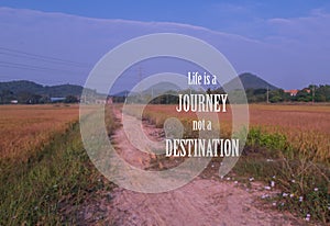 Inspiration and motivation quote on blurred rice field background photo