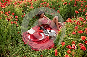 Inspiration from nature. Spring woman on poppy flower field.