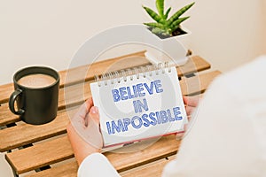 Inspiration showing sign Believe In Impossible. Internet Concept motivation and inspiration that you can make it happen