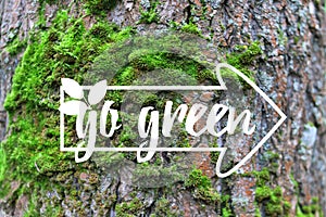 Inspirational banner Go Green banner decorated hand drawn leave, index on the green moss tree bark background