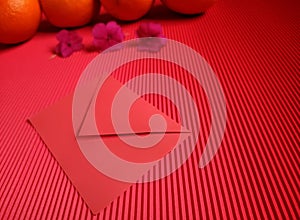 inspirational chinese new year concept image of red envelope,flowers and oranges in red colour background