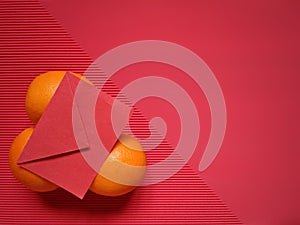 inspirational chinese new year concept image of red envelope on oranges in red colour background