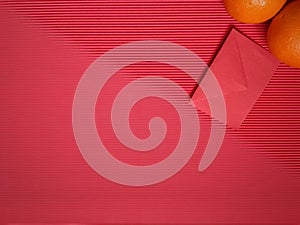 inspirational chinese new year concept image of red envelope and oranges in red colour background