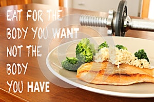 inspirational healthy eating quote on food and dumbbell background