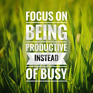 Inspirational motivating quote on nature background. Focus on being productive instead of busy