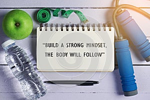 Inspirational motivating quote on notebook. Build a strong mindset, the body will follow.