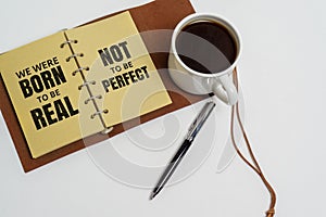 Inspirational and motivation life quote. Notepad and coffee cup.