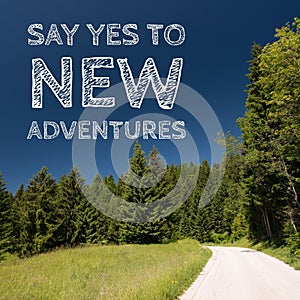 Inspirational motivation quote on natural landscape background, say yes to new adventures.