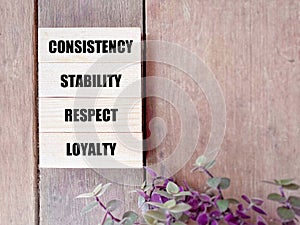 Inspirational and Motivational Concept - consistency stability respect loyalty text background. Stock photo.