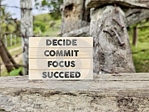 Inspirational and motivational concept - decide commit focus succeed text background.