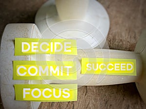 Inspirational and Motivational Concept - DECIDE COMMIT FOCUS SUCCEED text on stickynotes background. Stock photo.