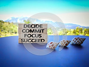 inspirational and motivational concept - Decide commit focus succeed text on wooden blocks with nature background