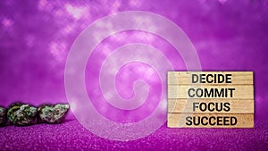inspirational and motivational concept - Decide commit focus succeed text on wooden blocks with purple vintage background