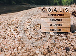 Inspirational and motivational concept text of GOALS DETERMINATION MOTIVATION WILLPOWER RESILIENCE. Stock photo.