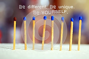 Inspirational motivational quote - Be different, be unique, be yourself. With wooden match sticks standing on bright background.