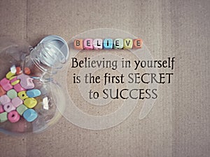 Inspirational and motivational quote of believing in yourself is the first secret to success. Text background. Stock photo.