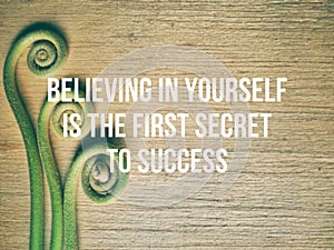 Inspirational and motivational quote of believing in yourself is the first secret to success in vintage style background.