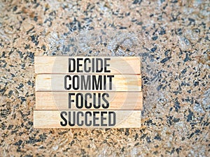 Inspirational motivational quote - decide commit focus succeed on wooden blocks