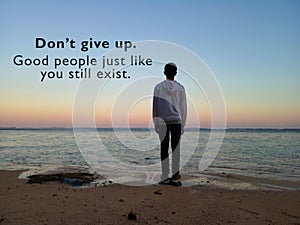 Inspirational motivational quote - Do not give up. Good people just like you still exist. With blurry image of young man standing