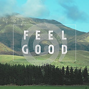 Inspirational motivational quote `Feel Good.` with mountain view background.