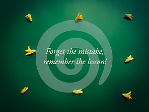 Inspirational and motivational quote of forget the mistake remember the lesson in vintage background. Stock photo.