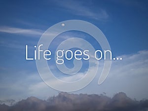 Inspirational motivational quote - Life goes on. With simple text messages design written on bright blue sky background.