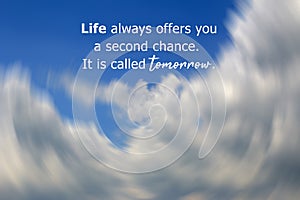 Inspirational motivational quote - Life always offers you a second chance. It is called tomorrow. On background of blue sky.