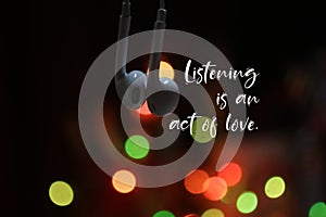 Inspirational motivational quote - Listening is an act of love. With earphone standing together on colorful light bokeh background