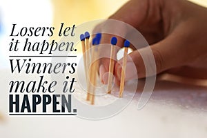 Inspirational motivational quote - Losers let it happen. Winners make it happen. With background of hand holding matches.