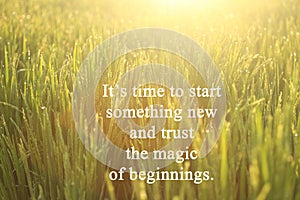 Inspirational motivational quote-It is time to start something new and trust the magic of beginnings. With morning golden light photo